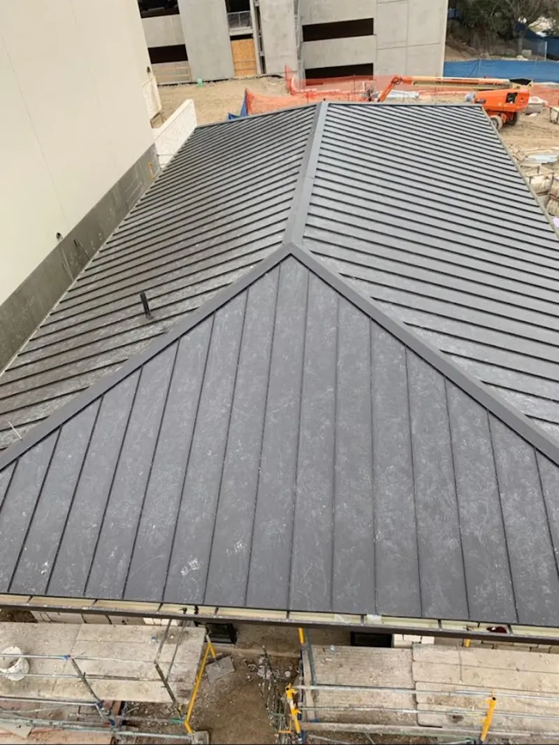 Commercial metal roof construction with crane equipment in Pendleton